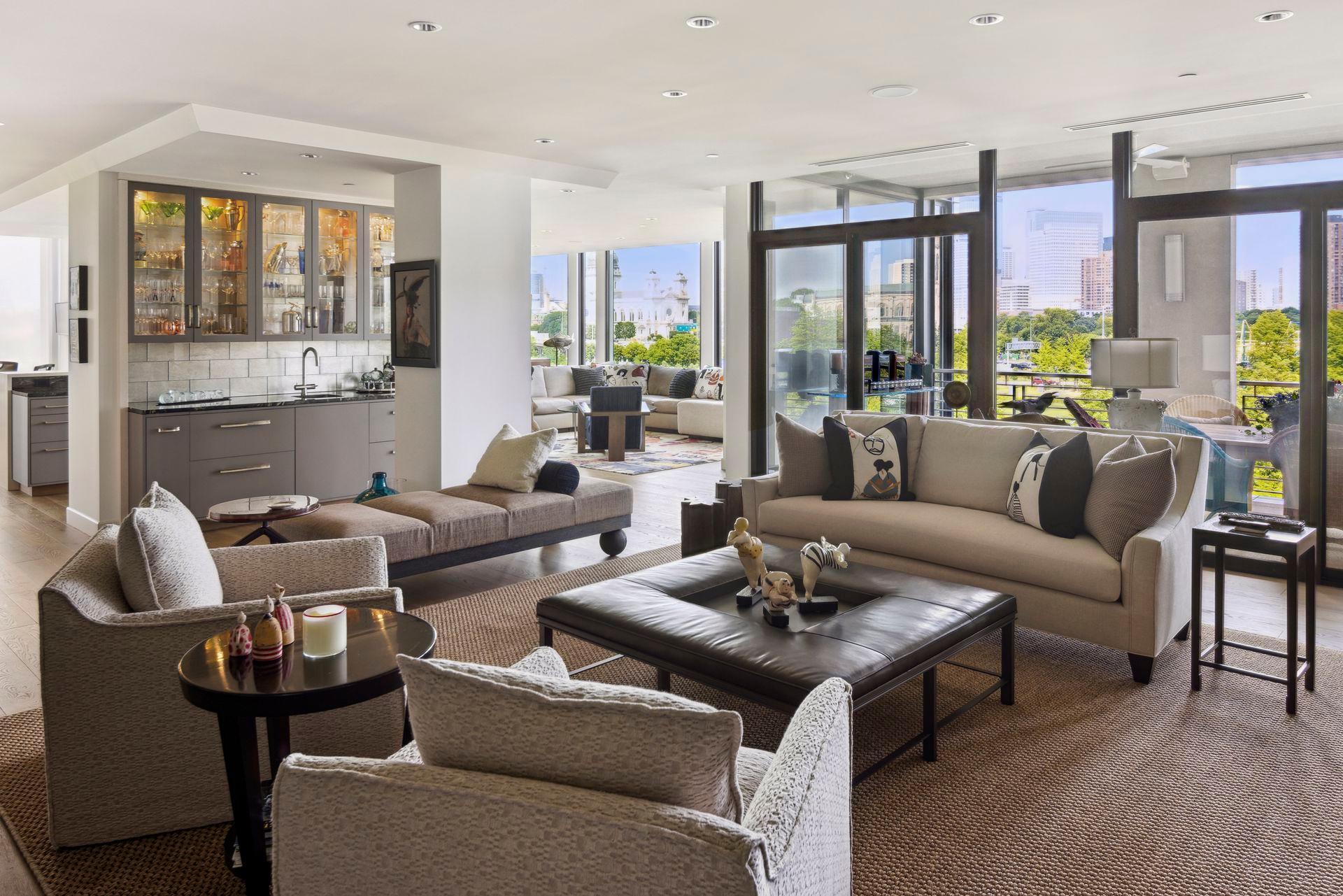 The glass wall between living room and porch offers dramatic views.