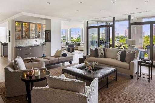 The glass wall between living room and porch offers dramatic views.