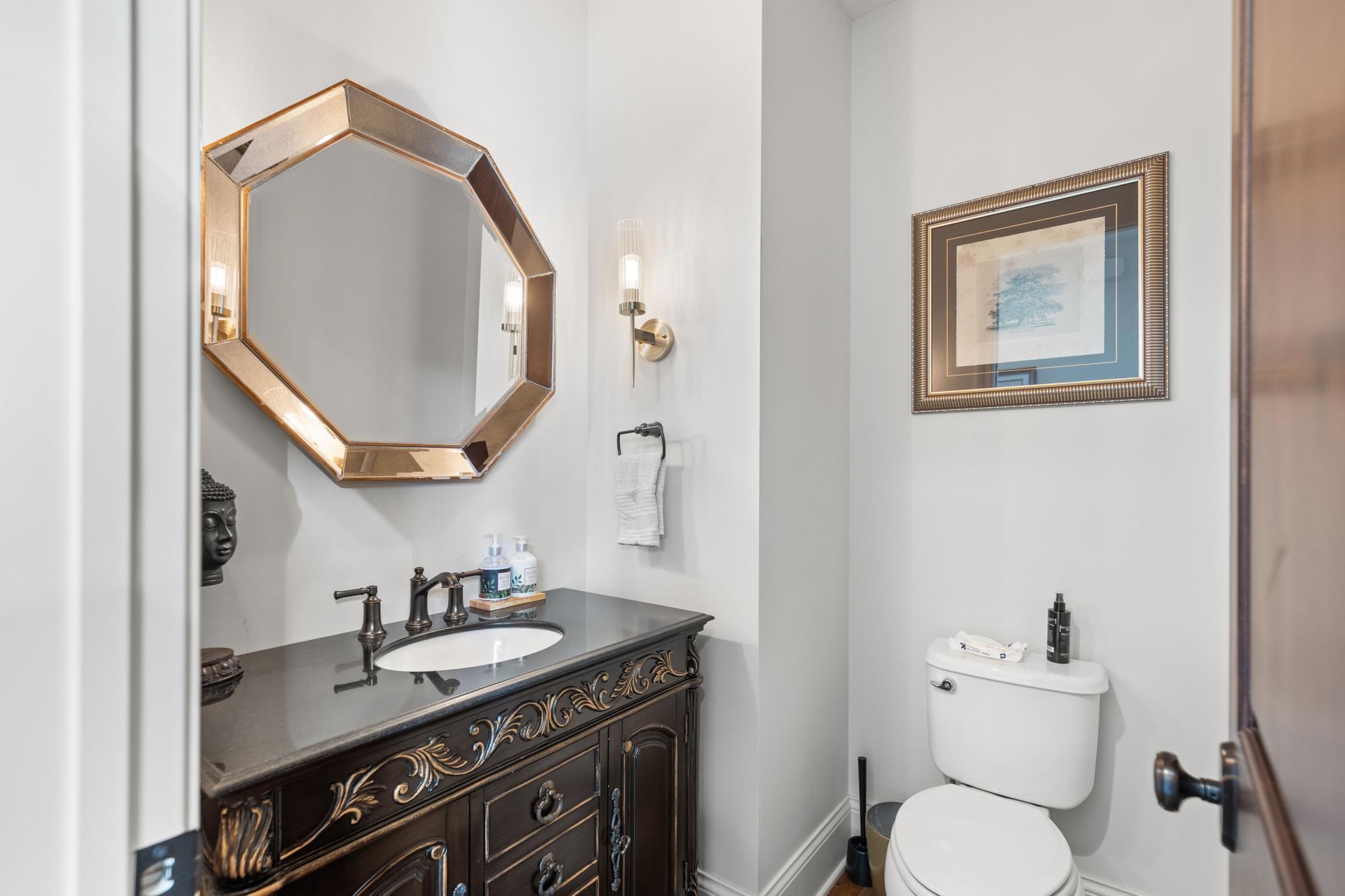 Main level powder room features lovely design elements