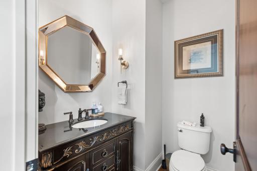 Main level powder room features lovely design elements