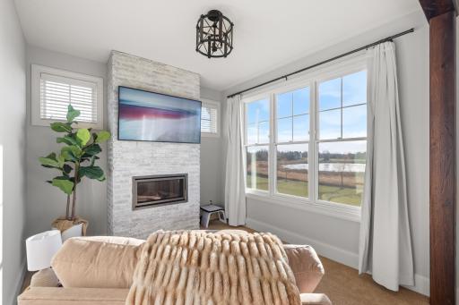 Cozy primary bedroom sitting room includes a gas fireplace. The perfect place to sneak away and relax