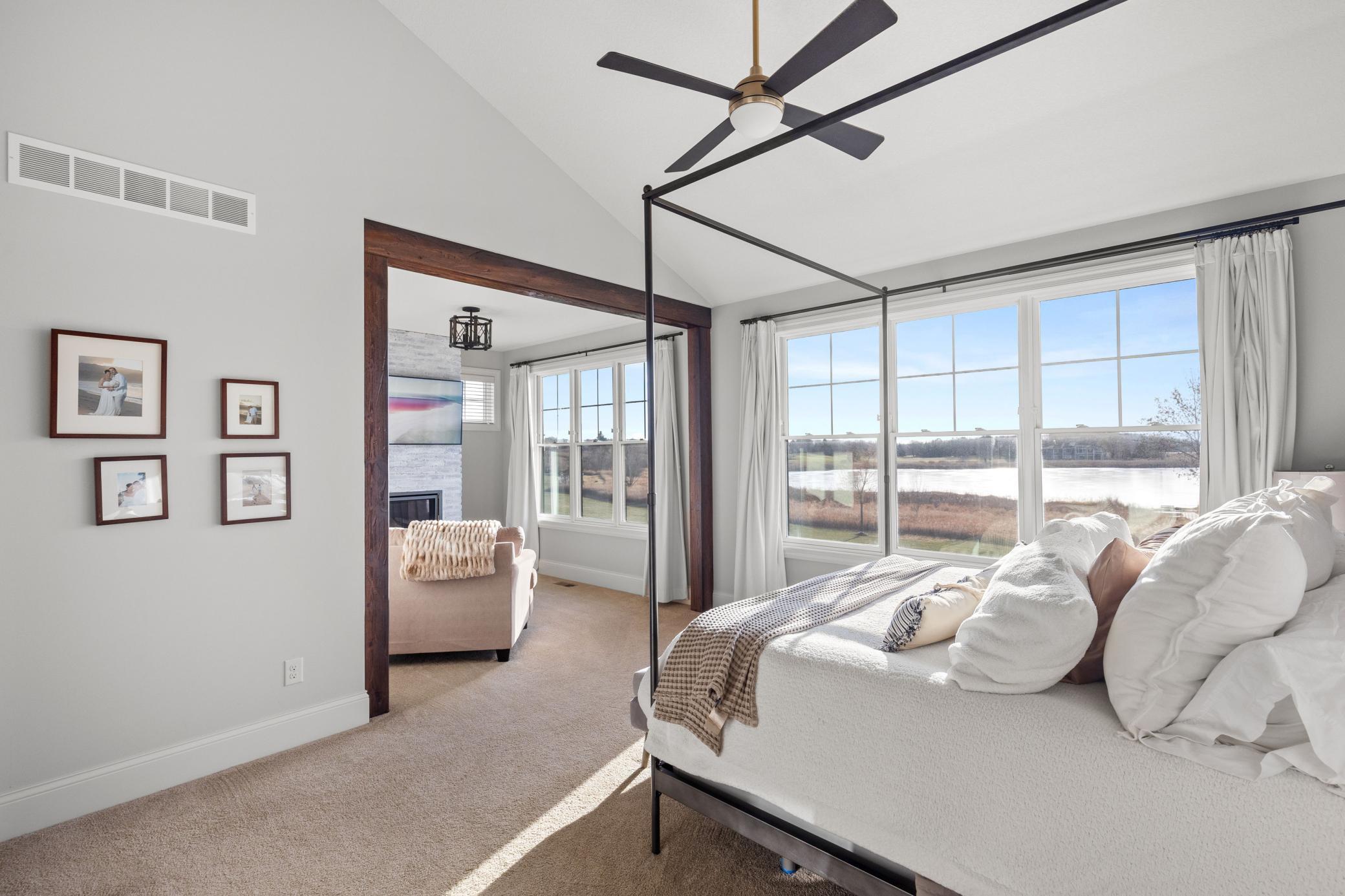 Stunning main level primary suite features vaulted ceilings, private sitting room & a plethora of natural light flowing through the windows