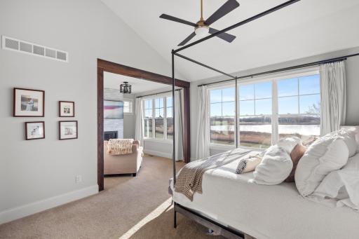 Stunning main level primary suite features vaulted ceilings, private sitting room & a plethora of natural light flowing through the windows