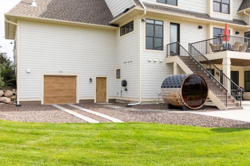 Exterior access to the tuck under garage. Barrel sauna negotiable in the sale.