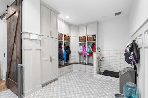 Mudroom includes plenty of storage in the built-ins and even a dog wash!