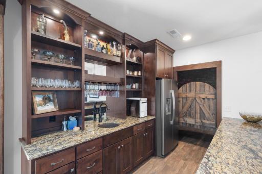 The bar leads to a lovely brick wine cellar behind the swinging doors
