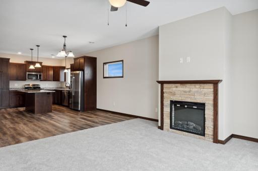 MODEL PHOTO - This home has WHITE CABS. Beautiful stacked stone fireplace adds to the ambience.