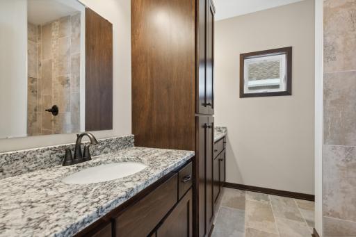 MODEL PHOTO - This home has WHITE CABS. Fine features meet functionality in your private bathroom with vanities separated by custom cabinet for all your toiletries and bath towels!