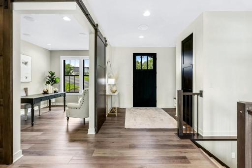 Generous size foyer with full panoramic views to the beautifully landscaped yard. Unique corner barn doors make the office warm and inviting. Power blinds. Electrical outlet & shelving for hidden printers/devices in hall closet.