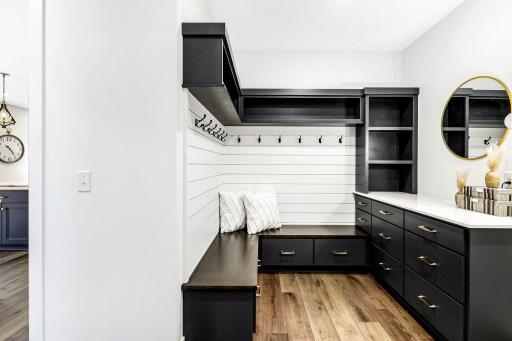 Huge mudroom with plenty of storage space and counter tops.