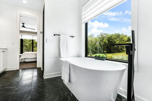 Ownerâs Suite with ensuite bath, closet, and main level laundry all connected
Heated floor in ensuite bath Powered blinds in ownerâs suite, its ensuite bathroom,