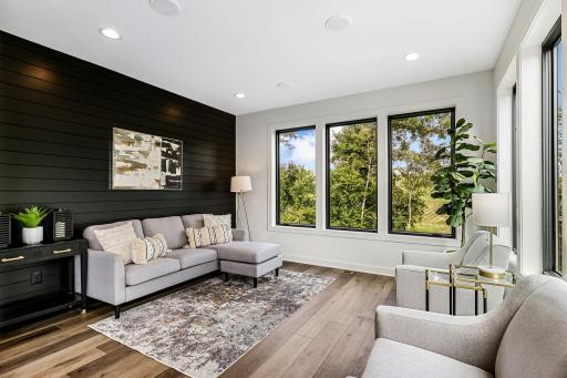 Den or cocktail area adjacent to kitchen. Over size Pella windows & beautiful finishes makes this room amazing!