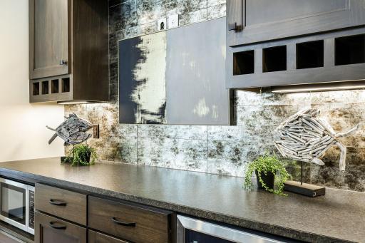 Beautiful backsplash and plenty of counter space. Reverse osmosis drinking water system and bar to sink.