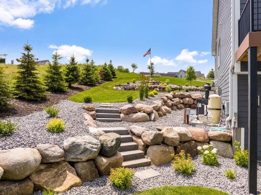 Beautiful retaining walls and steps lead to the front yard.