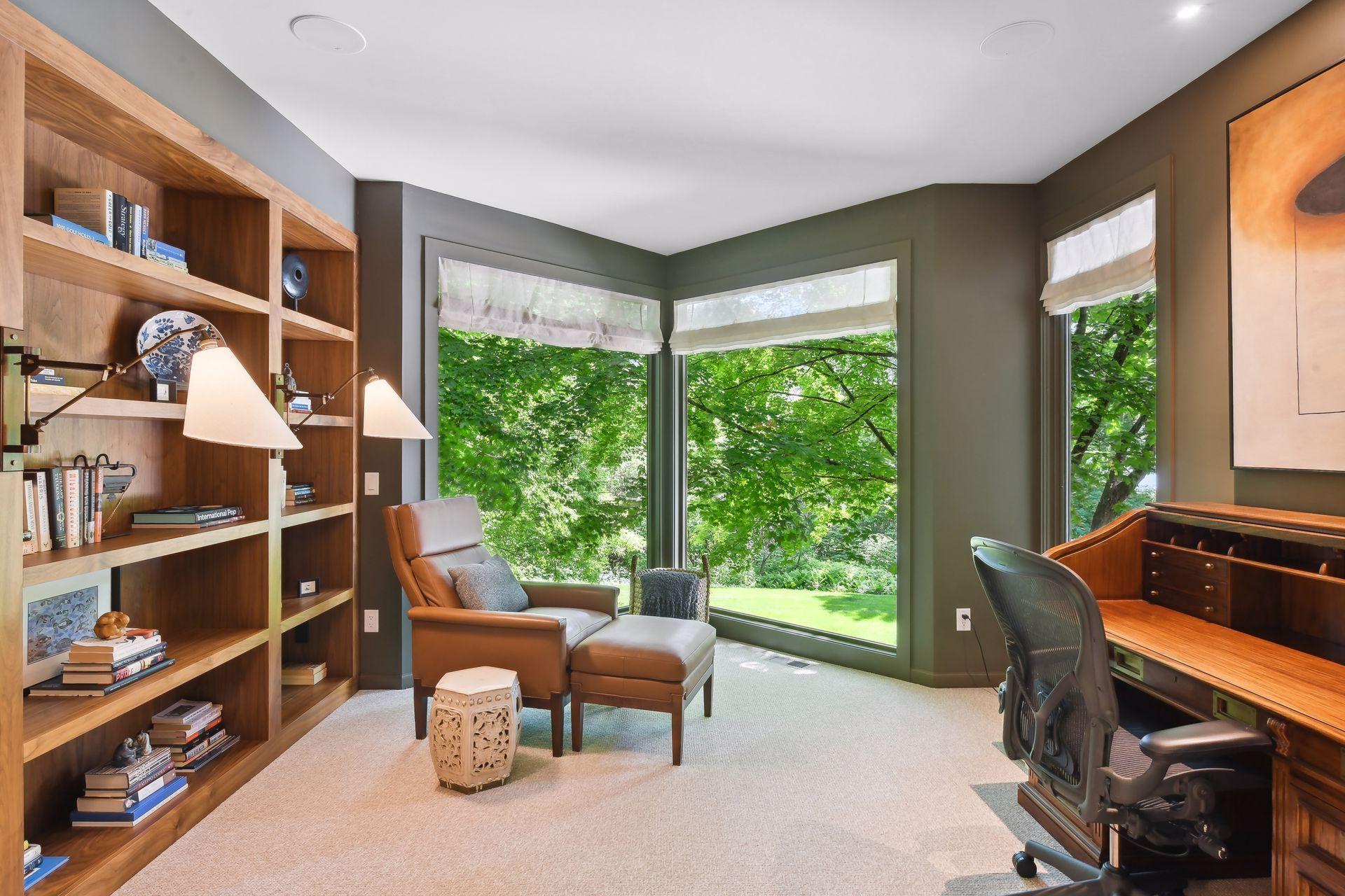 The office or sitting room of the primary suite overlooks the backyard pool.