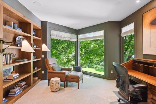 The office or sitting room of the primary suite overlooks the backyard pool.