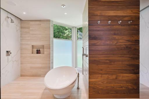The large soaking tub also has a tranquil waterfall feature that flows from the ceiling.