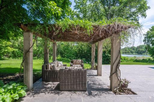 Covered in wisteria, the pergola is a wonderful place to lounge.