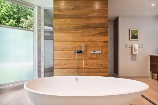 The toilet is concealed behind the gorgeous wall.