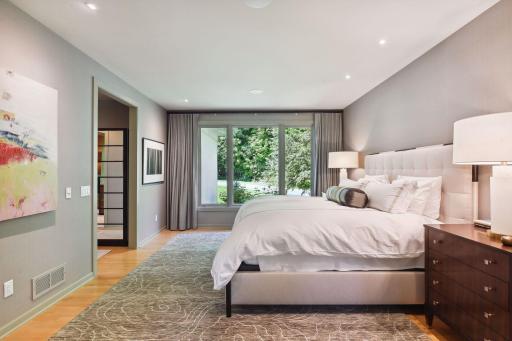 Solid maple floors span across the primary bedroom.