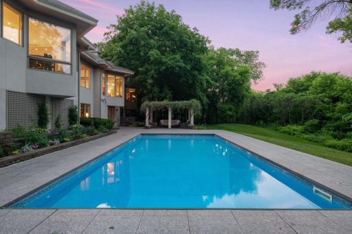 Introducing 930 Cox Farm Road in Orono, Minnesota. Outdoor amenities include a saltwater pool, hot tub, pergola, patio and dock surrounded by professionally manicured grounds for a resort-style living experience.
