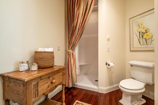 Main floor 3/4 bathroom off of the 2nd bedroom features a pedestal sink and walk-in tile shower.