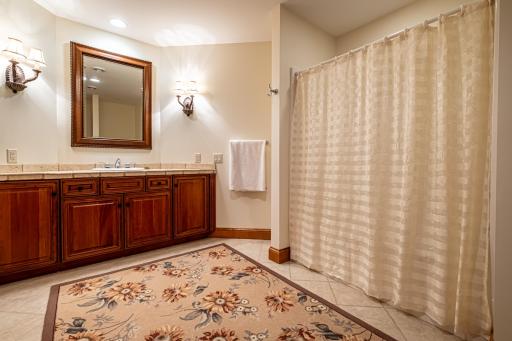Lower level full bathroom features recessed lighting, tile flooring, and a tub and shower combination.