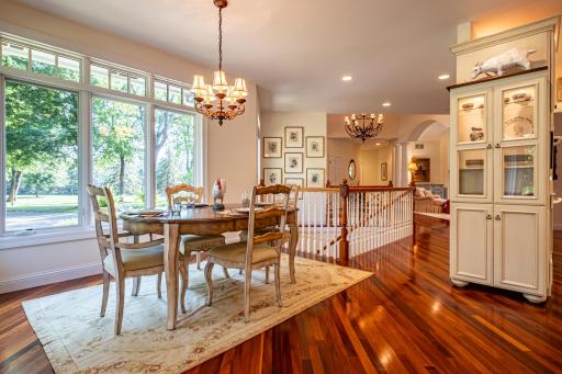 Informal dining room features Brazilian walnut flooring and large picture windows.