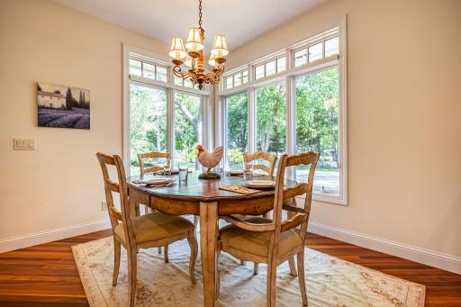 Informal dining room features Brazilian walnut flooring and large picture windows.
