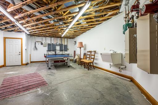 One of two mechanical rooms. Walk-out access to the garage. First mechanical room features a Kinetico water softener system, water filtration system, Marathon electric water heater, and Lennox forced air furnace with air-to-air exchanger.