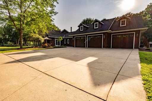 Cedar siding, 40 year Presidential shingles, and concrete driveway with separate paver driveway to the front entrance.