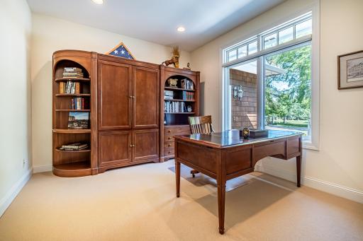 Office on the main floor features a large picture window and recessed lighting.