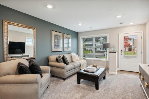 Lovely and inviting great room that features large windows for plenty of natural light. *Photos are of another model, colors and finishes may vary.