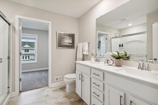 Private owners suite bathroom with double sink vanity and walk in shower! *Photos are of a model home, some features and colors may vary.
