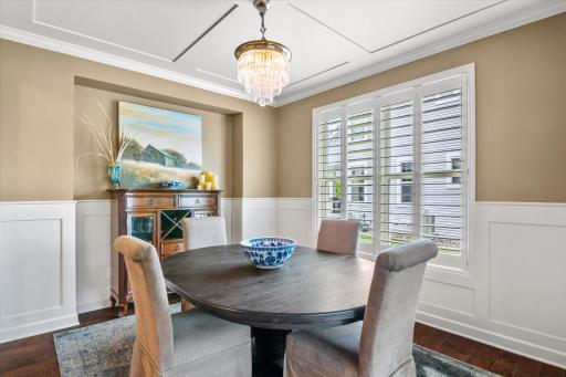 Semi formal dining, notice the wainscoting on the walls and the trey ceilings. The light does not stay with the home, sellers will replace it with a standard light fixture.