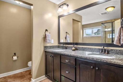 Private en-suite in the primary bedroom with a double vanity.