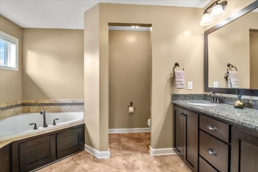 Private primary full bathroom with a separate soaking tub and shower.