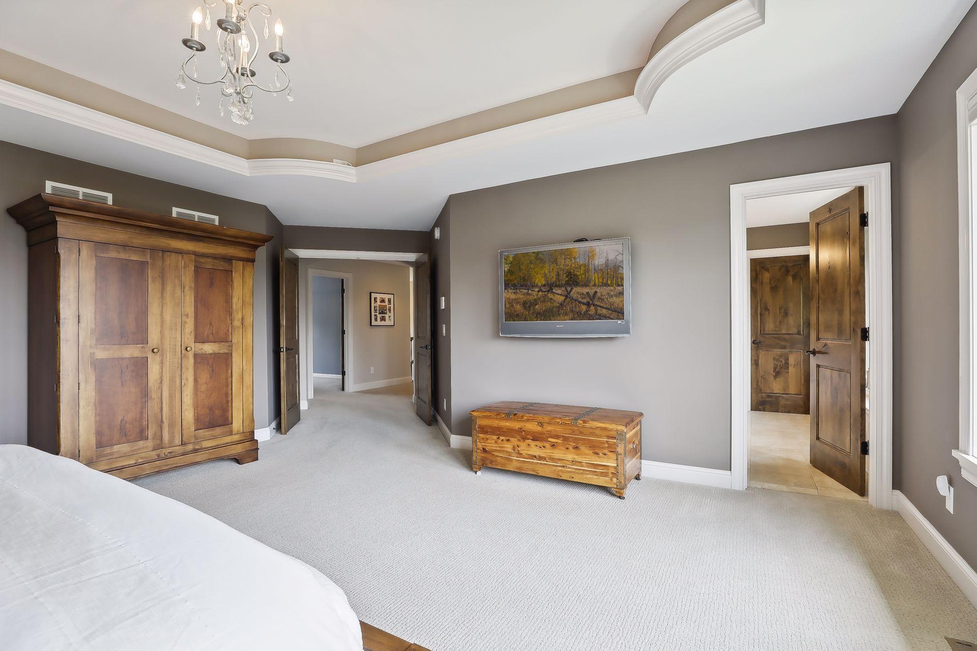 The primary suite features luxurious spa-like bathroom, custom walk-in closet with laundry attached.