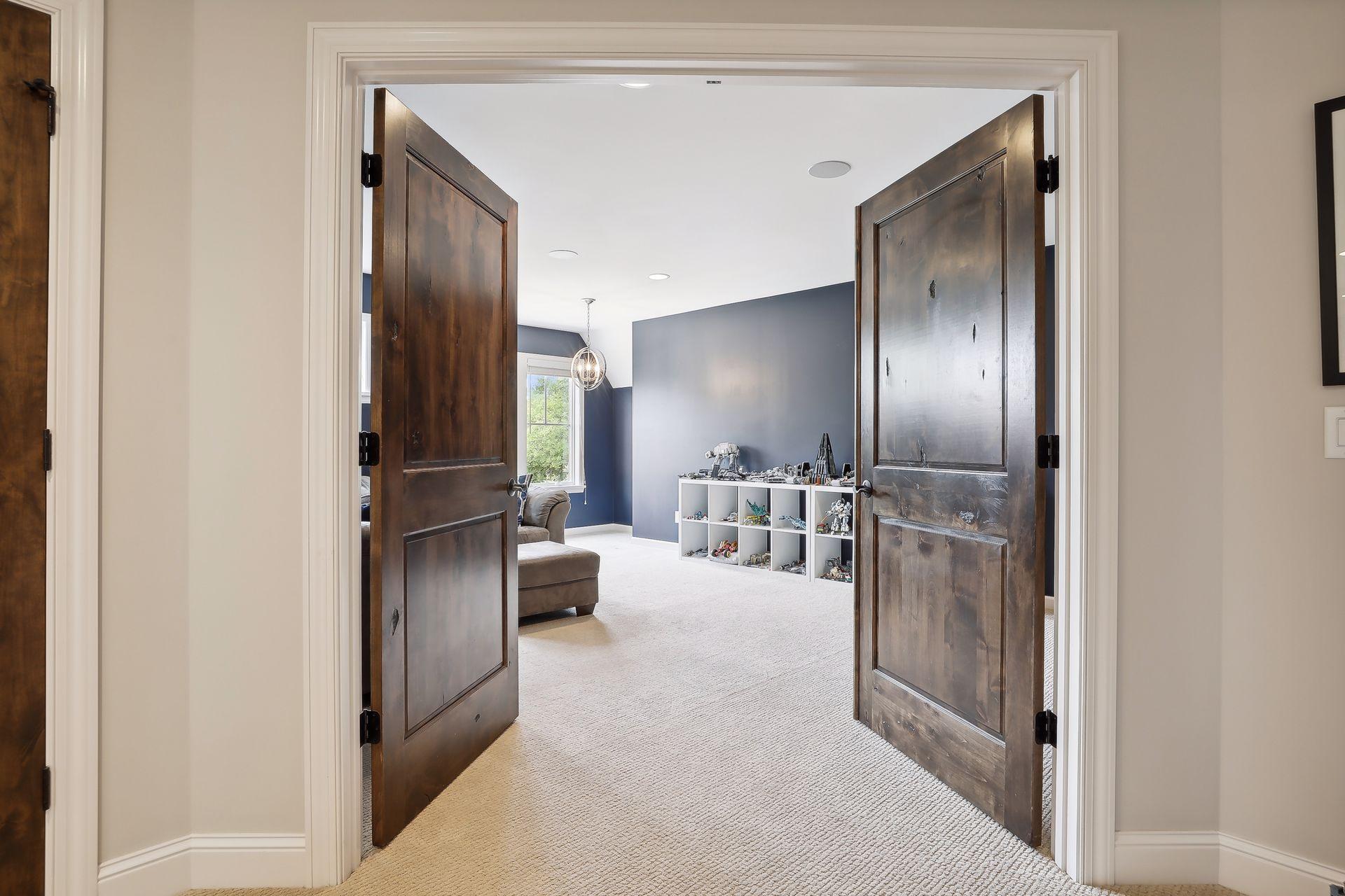 Dramatic double-door entry to the bonus room / 6th bedroom.