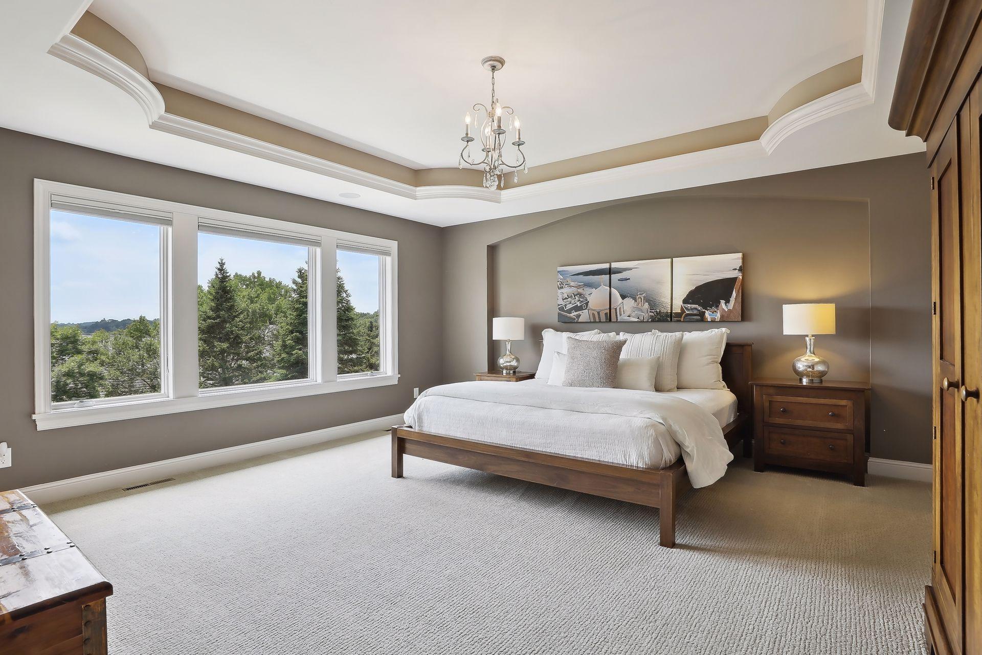 Nothing spared in the primary suite that showcases an arched bed wall, huge windows and step-up ceiling.