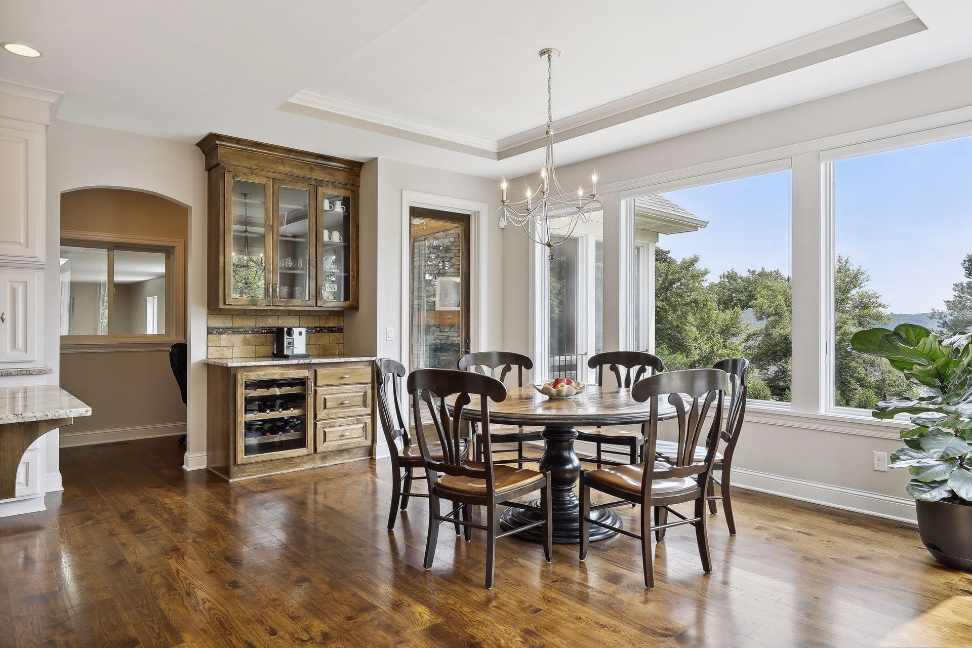 Wall of windows lets the sunlight pour into the informal dining area.