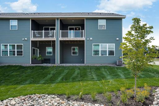 Rear of the building showing your own private balcony and covered patio! Colors and finishes may vary.