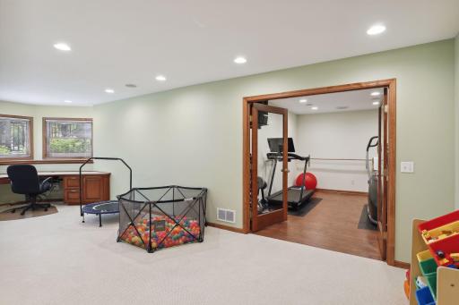 Exercise room has mirrored wall & ballet bar