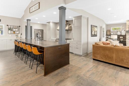 Stunning stained maple floors grace the main level, as do quartz counters in the kitchen and all bathrooms