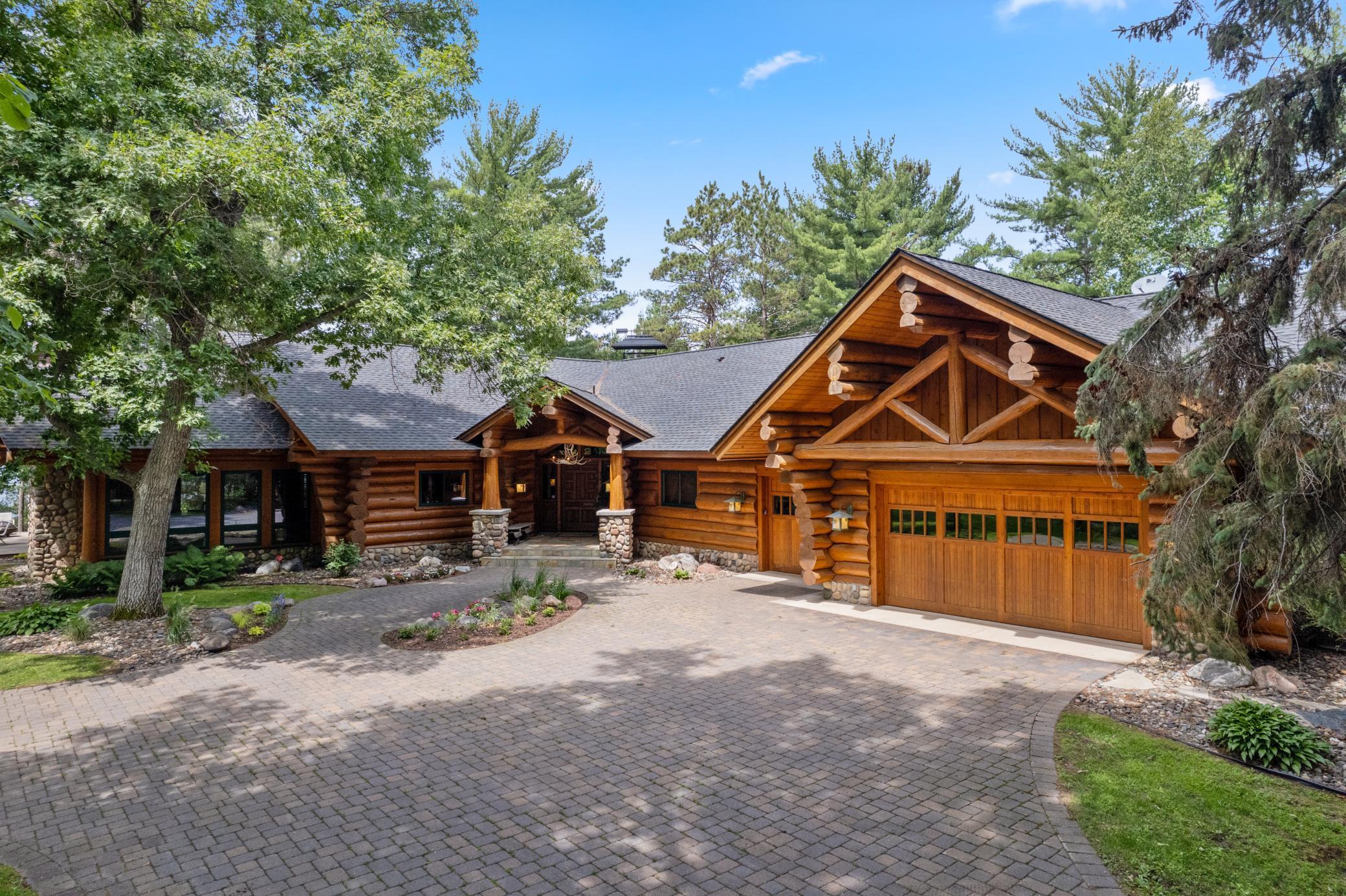 This majestic property encompasses three log cabins with breathtaking views across three lakes. The stunning Main Cabin boasts three king suites, five bathrooms, four fireplaces and a three-car garage overlooking Lower Whitefish Lake.