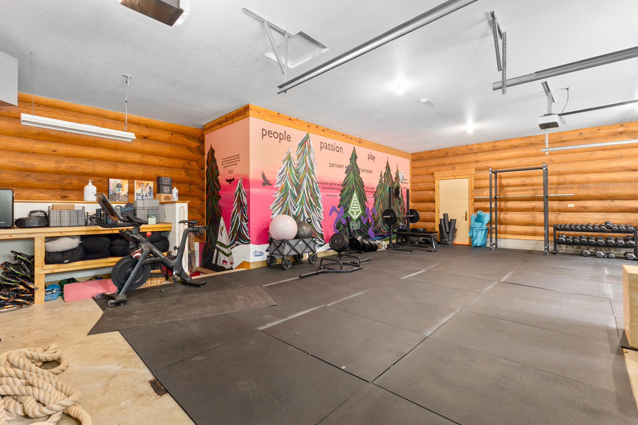 Attached three car garage is currently being used as a home gym.