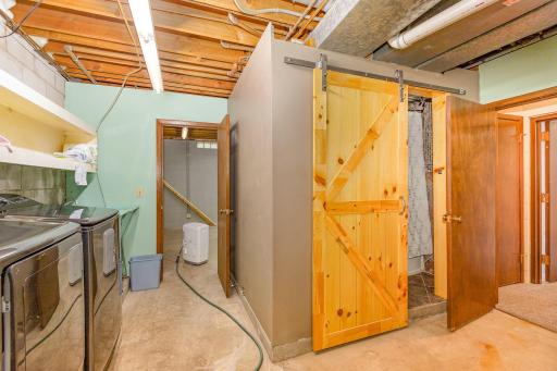 Lower level laundry room. Full bathroom behind the barn door!