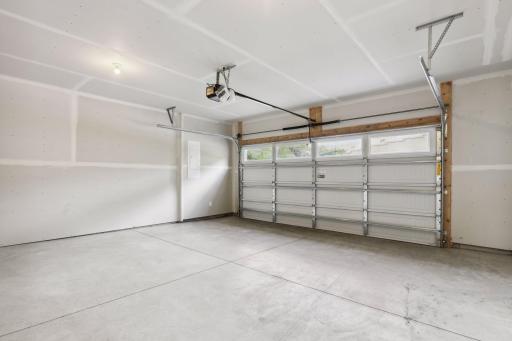 The garage has a side bump-out for trash, recycling and shelving space.
