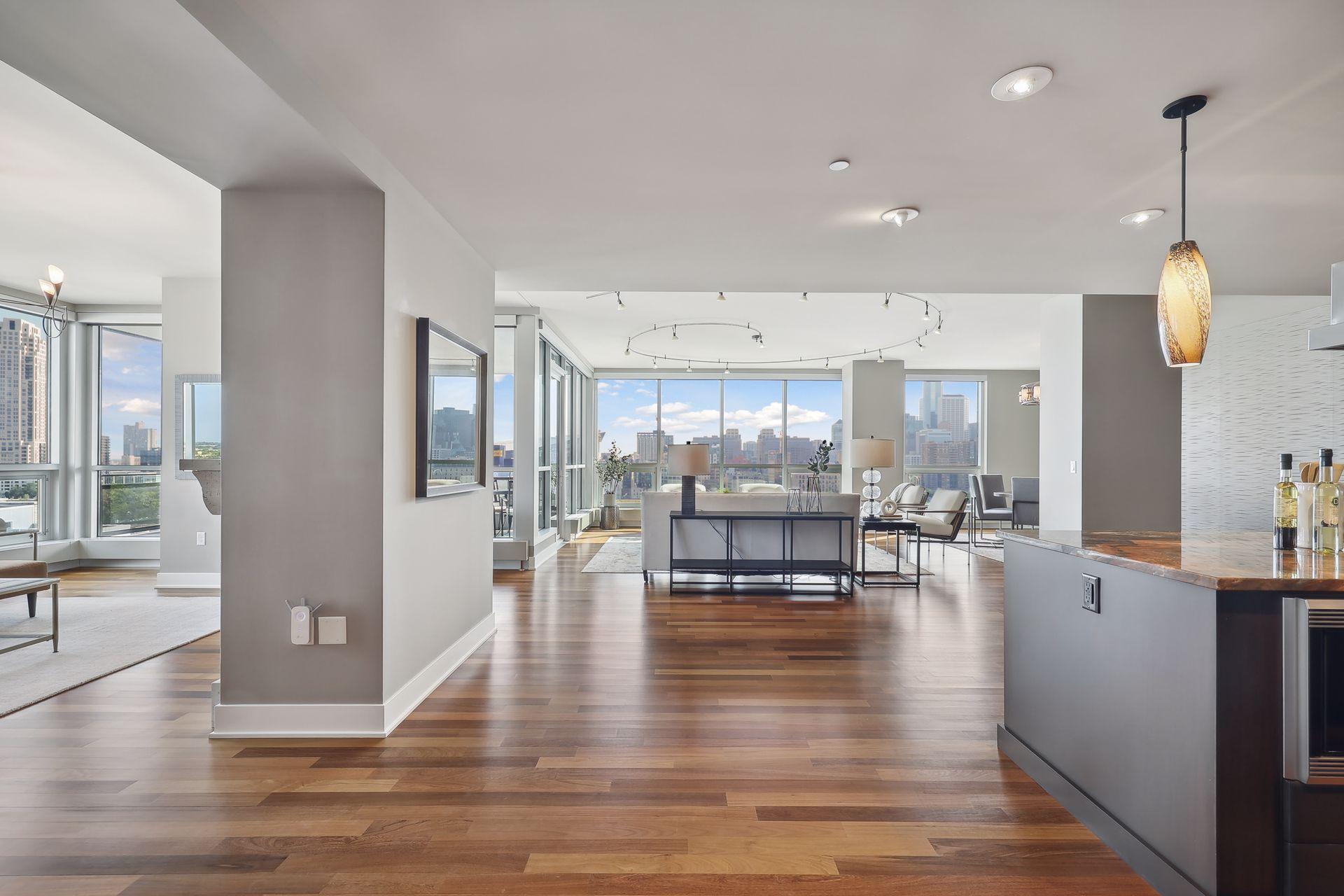 Wow! This image captures a bit of each main area, media room to the left, dream kitchen to the right with centrally located main living area beyond.
