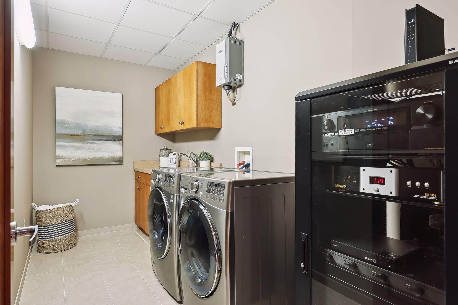 LG oversized front loading washer and dryer, the components for the whole house audio system and humidifier system are also housed in this area.